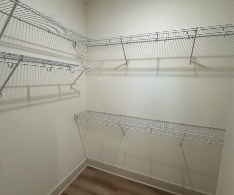 Walk-in closet with LVP flooring and wire shelving in Liberty Road home