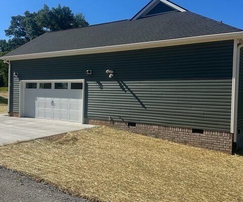 Side exterior and attached garage of Liberty Road home in Charlotte, Tennessee